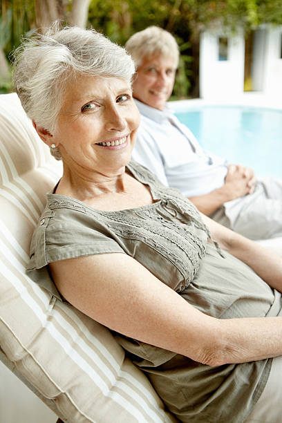istock Smiling senior woman with man by poolside 184373237