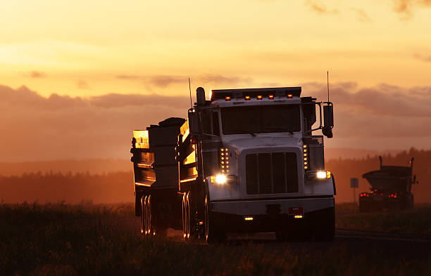 Transfer Dump Truck. A transfer dump truck hauling rocks at sunset. dump truck photos stock pictures, royalty-free photos & images