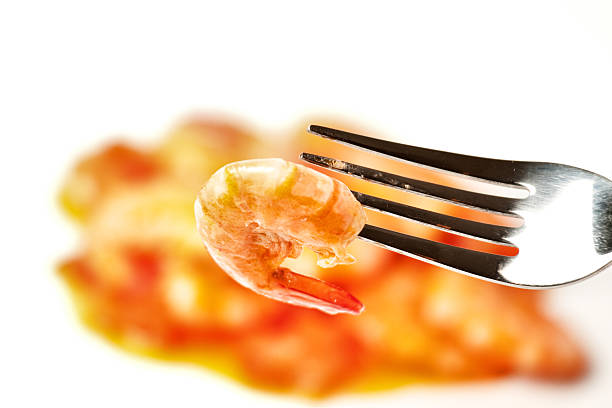 Close-Up Of Prawns In Plate Over White Background