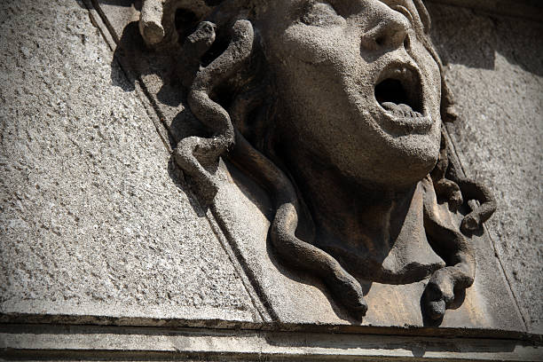 Head of Medusa A stone-carved Medusa mask on a building in Vicenza (Italy). spooky medusa italy mask stock pictures, royalty-free photos & images