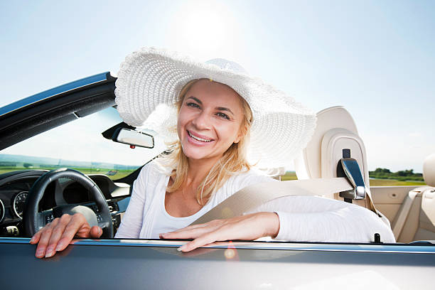 istock Smiling female sitting in cabriolet and looking at the camera. 184374385