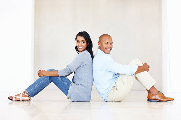 istock Smiling couple leaning against each other 184374506