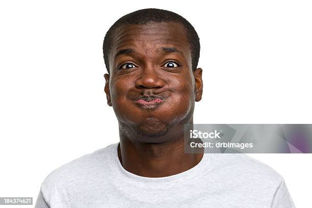 Portrait Of Young Man Making A Goofy Face Stock Photo - Download Image Now - Holding Breath, African Ethnicity, Portrait