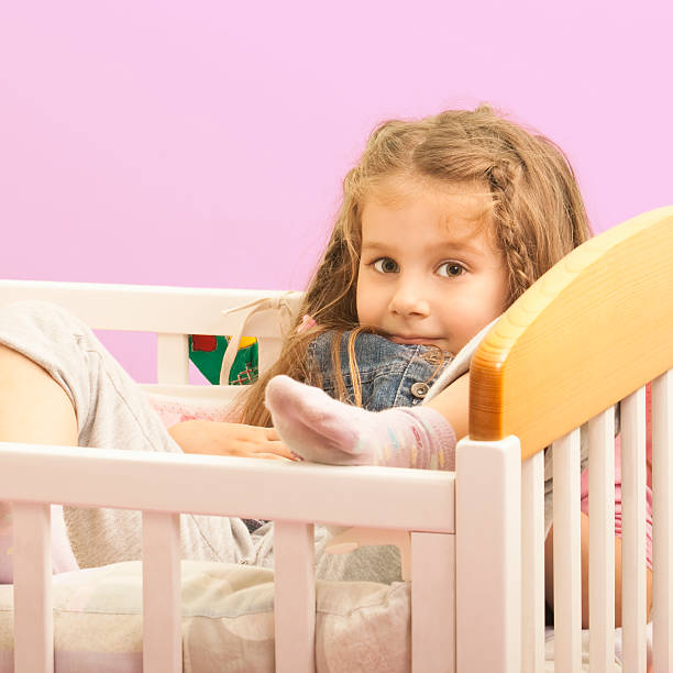 istock Little Girl is playing in her crib 184374762