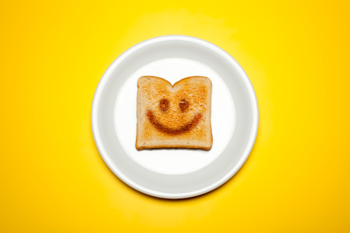 Concept photograph of a toasted toast on a plate and yellow background.