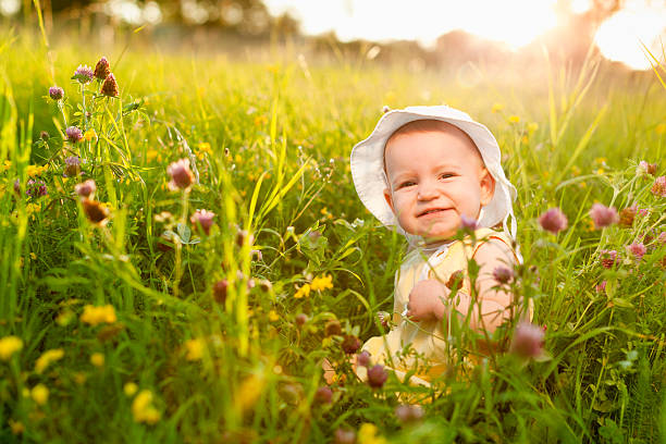 istock Baby girl on a summer meadow 184375164
