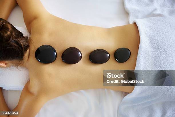 Woman Receiving Hot Stone Therapy Stock Photo - Download Image Now - Lastone Therapy, Adult, Adults Only