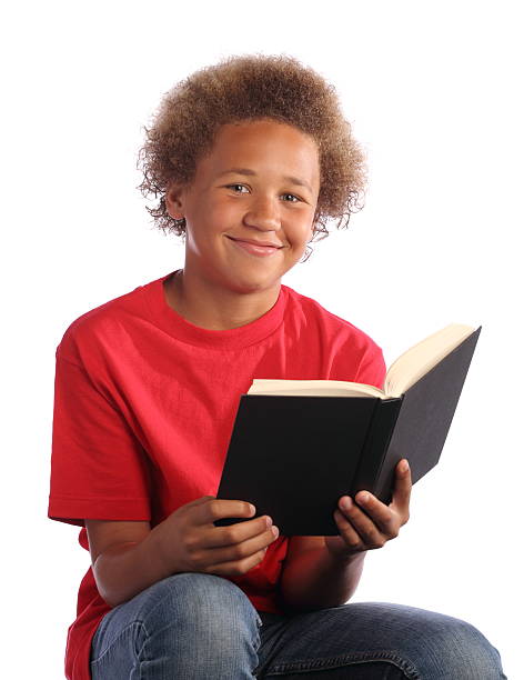 istock African American Boy Reads Book and Smiles 184375584