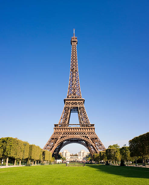 The Eiffel Tower in Paris France The Eiffel Tower on a clear blue sky summers day in Paris, France. eiffel tower stock pictures, royalty-free photos & images