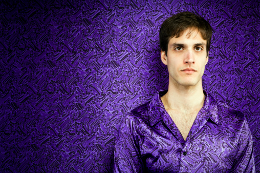 Young man in purple with copy space.