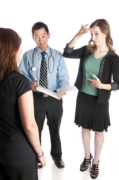 Sign Language Interpreter and Patient with Asian Doctor stock photo