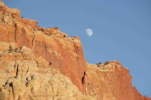 istock moon over large sandstone cliffs, Capitol Reef National Park 184376945