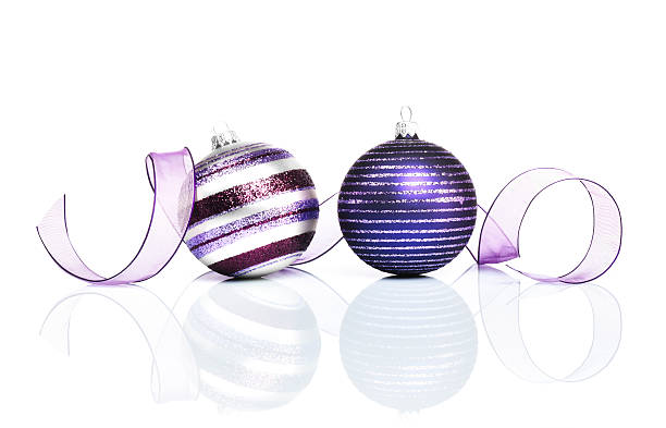 purple christmas decoration with christmas baubles and ribbon isolated on white