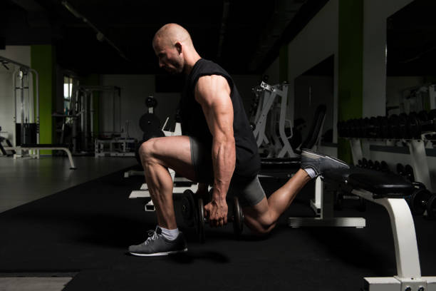 istock Man Athlete Exercising Glutes With Dumbbell 1843769627