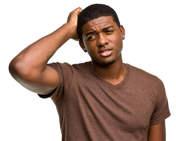 istock Confused Young Man Scratches His Head 184377381