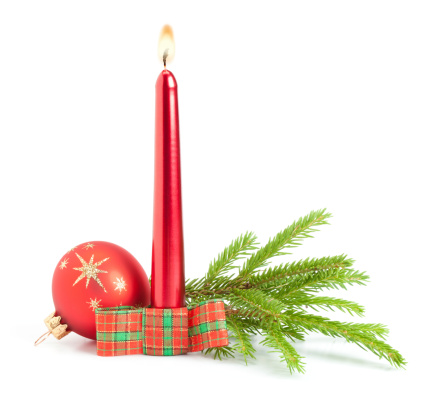 Red candle, bauble and pine tree branch on white background. This File is cleaned and retouched.