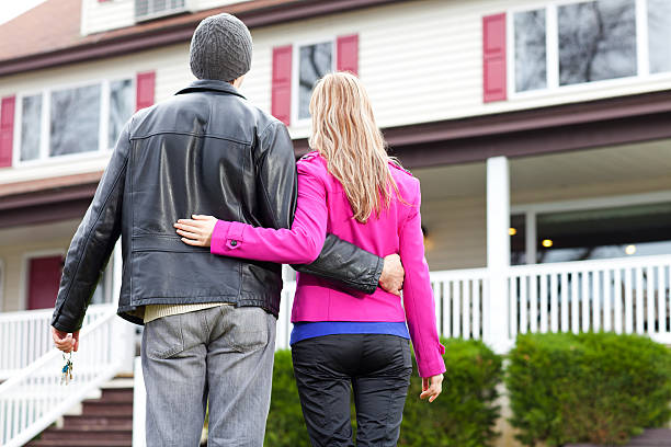 istock Young couple looking at their new house 184378460