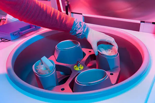 Scientist preparing centrifuge