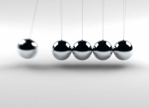 Newton balls (Isaac Newton's Cradle) with one ball in motion.