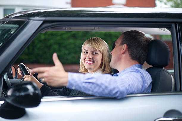 istock father and daughter driving lesson 184379265
