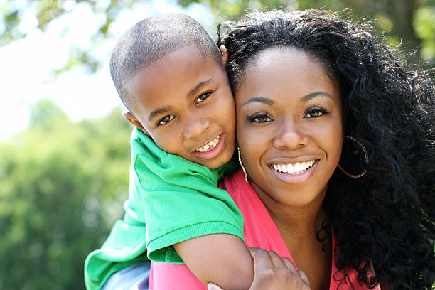 istock A smiling mother with her son over her shoulder 184379420