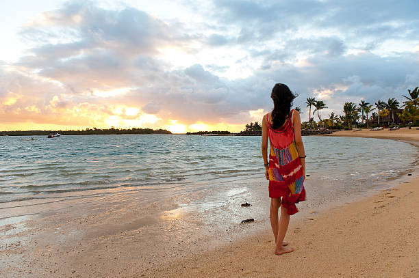 istock Chinese woman standing on empty beach 184379453