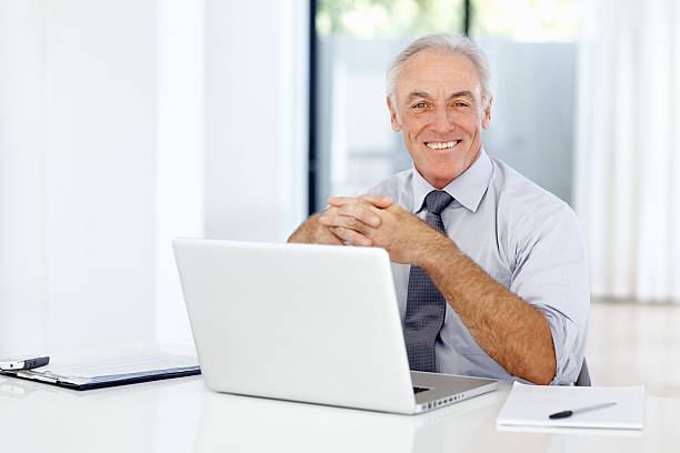 istock Smiling male executive with laptop 184379687