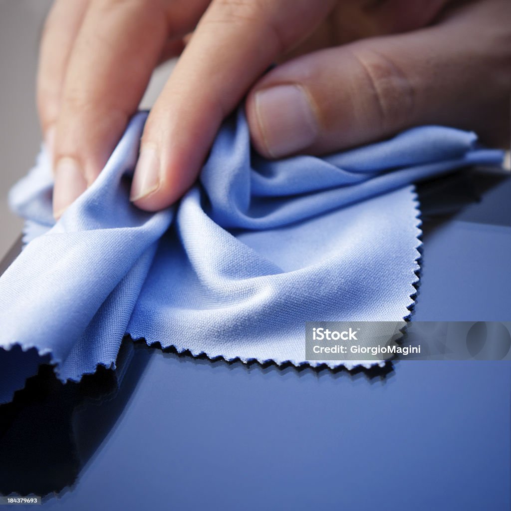 Cleaning Tablet PC with a Cloth Hand cleaning a tablet PC with a cloth. Shallow depth of field. Cleaning Stock Photo