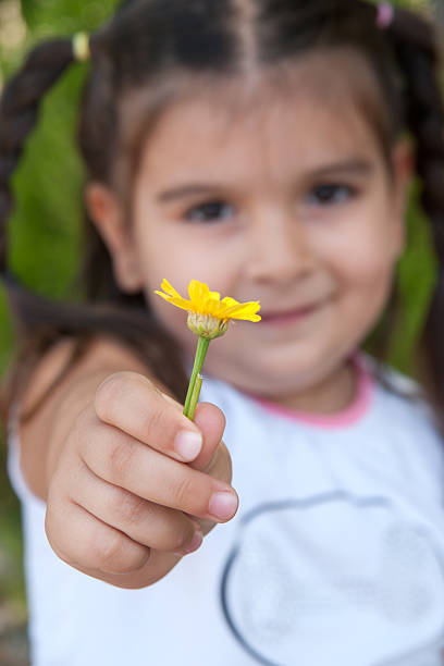 istock Little Girl Holding Flower 184379791
