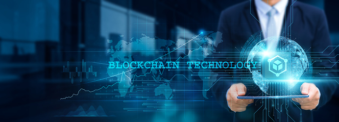 Blockchain technology, revolutionizing industries, Businessman use tablet and leverage smart contracts with structure of decentralized ledger on network for working in the futuristic financial.