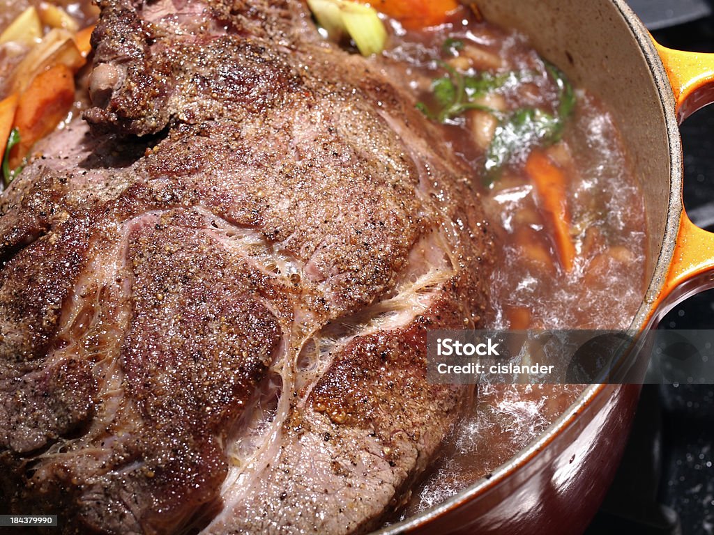 Pot Roast Pot Roast of Beef simmering on a black stove top. Beef Stock Photo