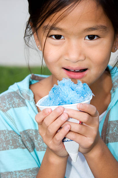 istock Chinese child with blue snow cone 184380126