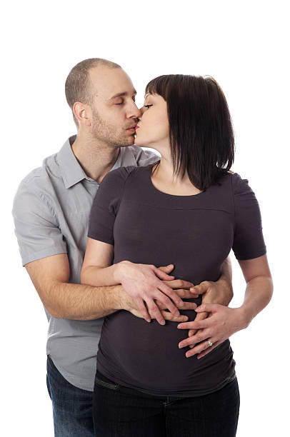 istock Pregnant couple kissing. 184380309