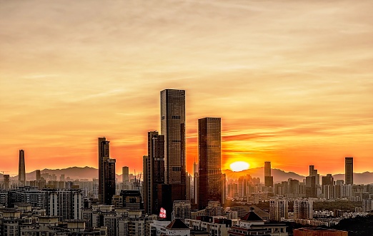 the sun is setting over a city with tall buildings, in the style of gongbi