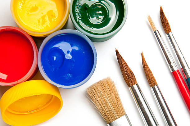 Watercolor paints, poster paints in mini cans, paintbrushes, isolated