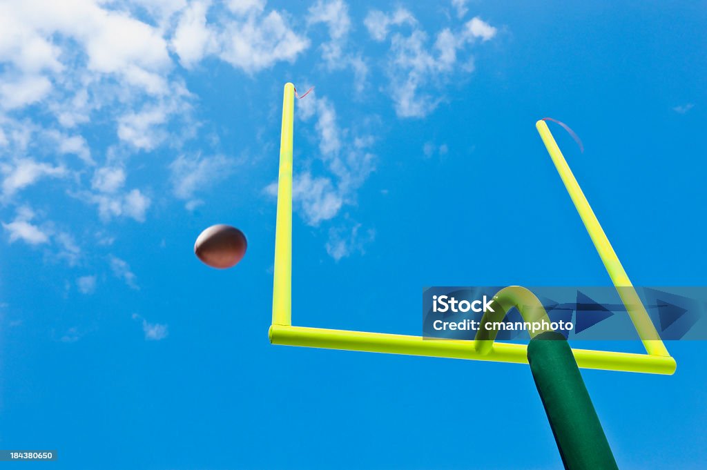 Missed Field Goal - American Football Missed - WIDE Right, Field Goal or Extra Point in American Football looking up at the yellow goal post as the ball misses going through the uprights Football Goal Post Stock Photo