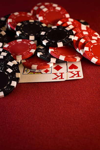 istock Pocket Kings with Poker Chips on Red Felt 184380694