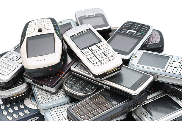 istock Old used cellphones pile close-up isolated on white 184380716
