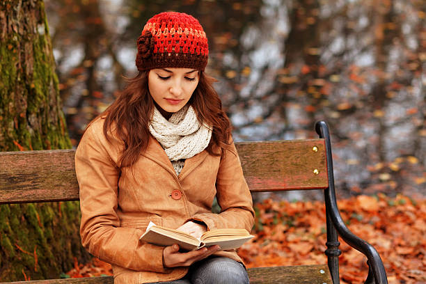 girl reading a book  in the autumn forest