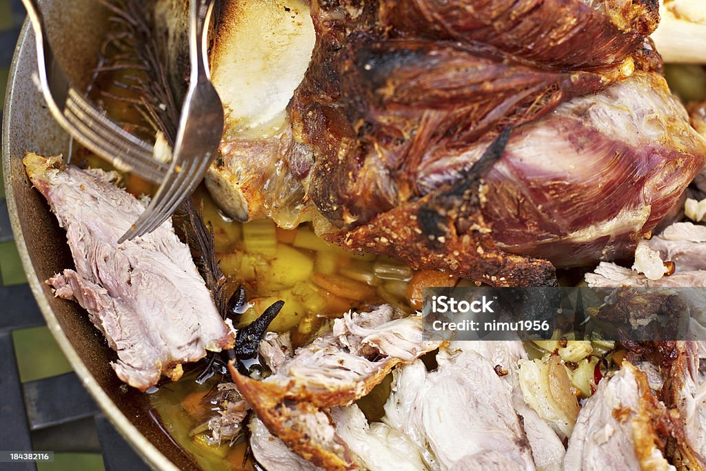 Cooked beef and pork shanks "Delicious beef and pork shanks, slow-cooked in the wood oven with vegetables.." Aluminum Stock Photo