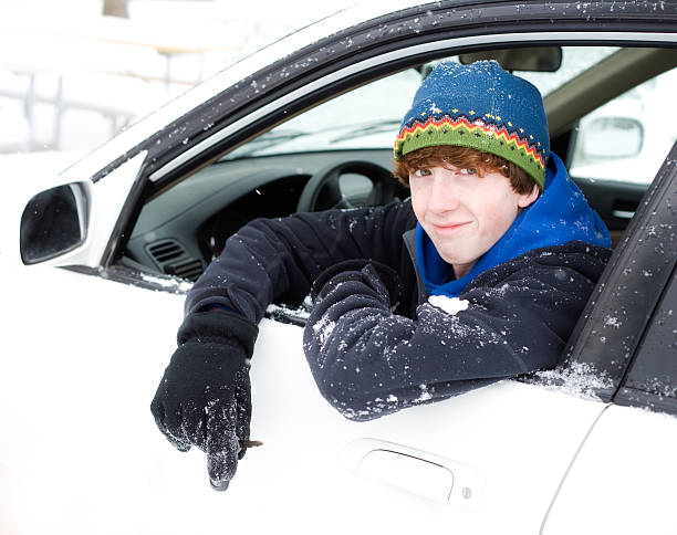 istock Handsome Teenager Driving in Snow 184382381