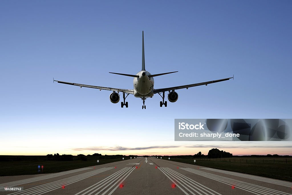 XXL jet airplane landing jet airplane landing on runway at twilight (XXL) Airplane Stock Photo