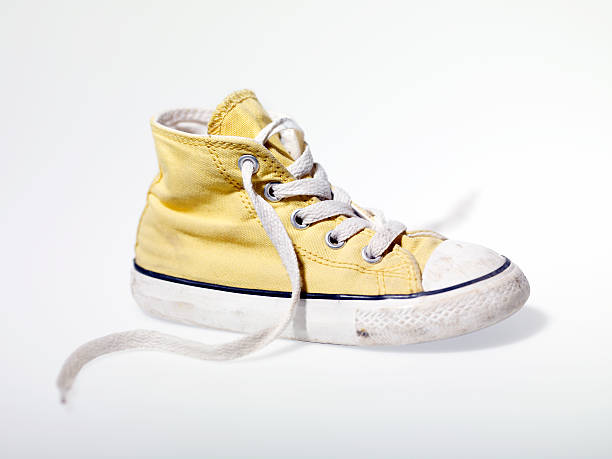 istock Yellow vintage sneakers isolated on a white background 184382879