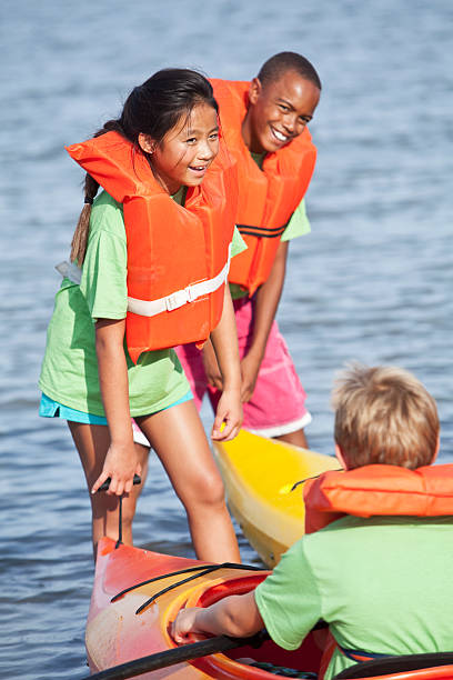 istock Children on water with kayaks 184383241