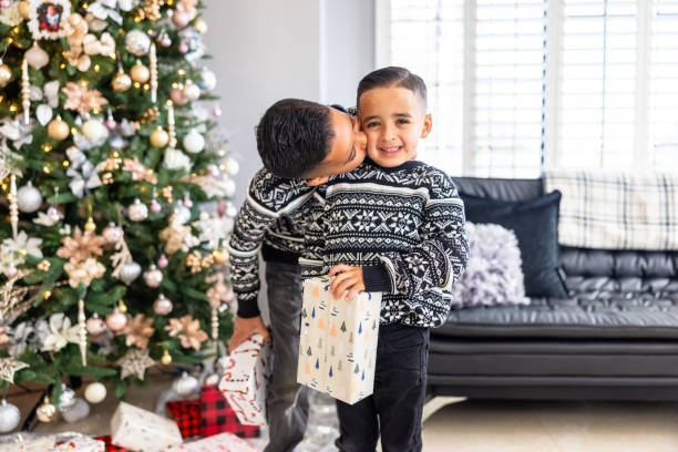 istock Cute boys with Christmas presents and a Christmas tree 1843837288
