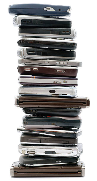 Really big stack of old mobile phones isolated on white