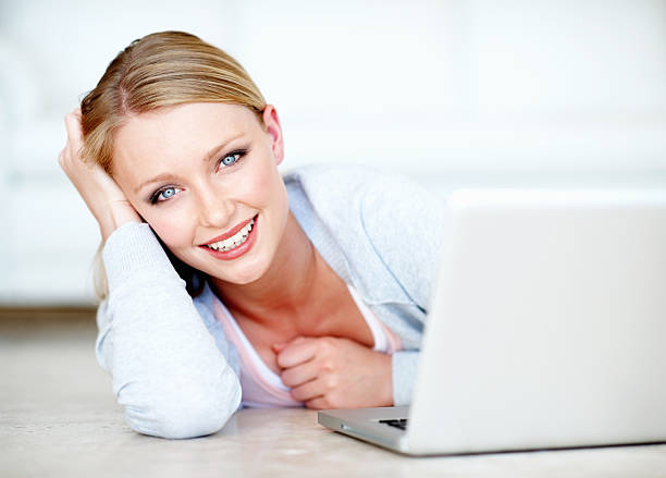 istock Pretty woman using laptop at home 184384384