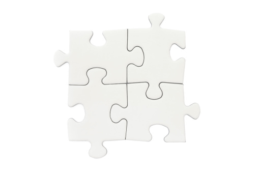 Four connected blank puzzle pieces isolated on a white background.