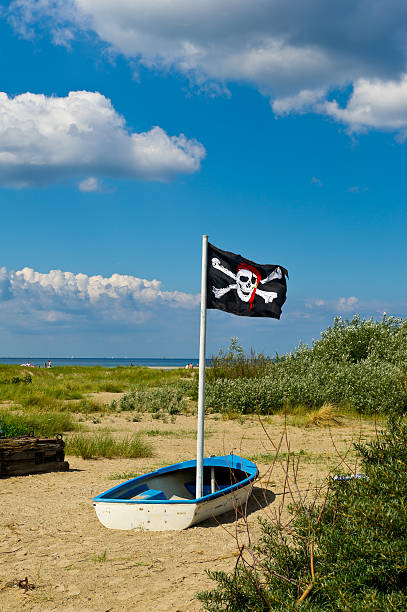 A Pirate Flag Flying at the Top of a Ships Mast.