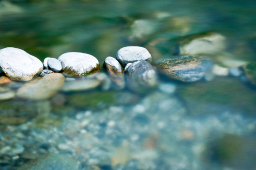 istock Pebbles and arranged stones in river water 184384660